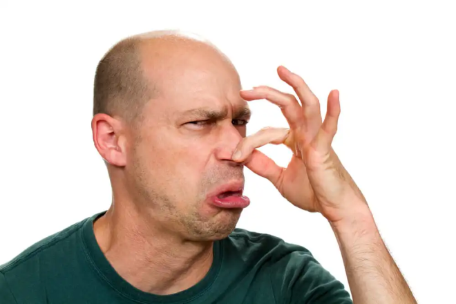 Gas bayonet fitting: a man pinching his nose due to the unbearable odor.