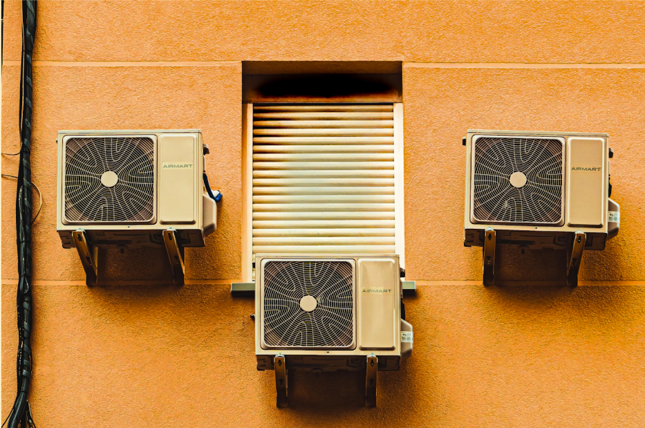 How does a gas heater work: three heat exchangers mounted on a yellow wall.