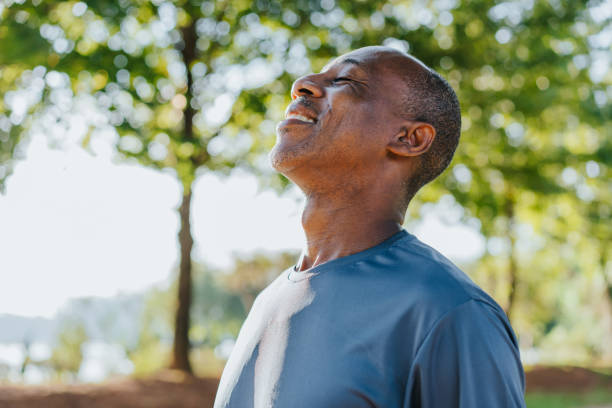Why do heat pumps require a high amount of servicing: a man breathing in fresh air while smiling.