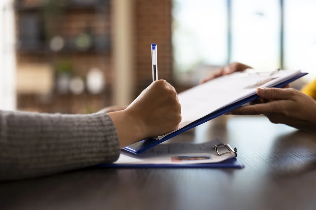Close-up of final paperwork being signed which is the last step when you remove your gas fireplace with the help of contractors