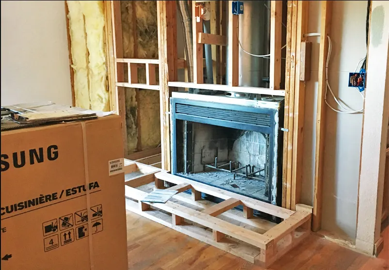 Exposed chimney framing during renovation to remove a gas fireplace
